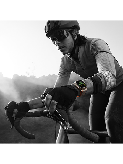Image of a person cycling while wearing the hypothetical Apple Watch Ultra 2, demonstrating its fitness tracking capabilities. The watch is shown on the wrist, tracking metrics such as heart rate, distance, and calories burned, providing valuable insights to enhance the cycling experience.